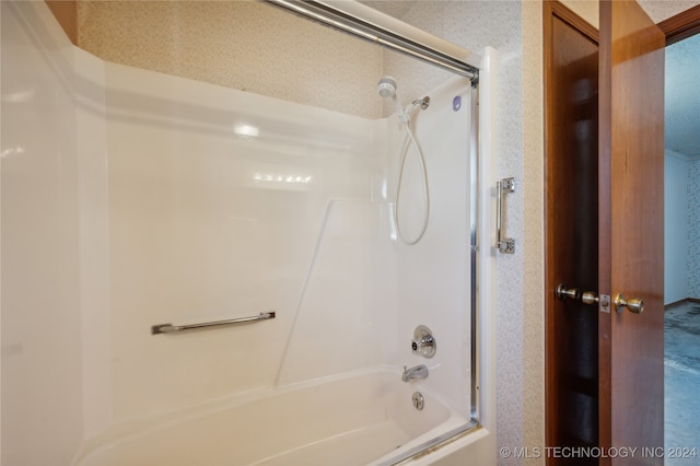 bathroom featuring shower / tub combination and a textured ceiling