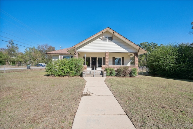 bungalow-style house featuring a porch and a front yard