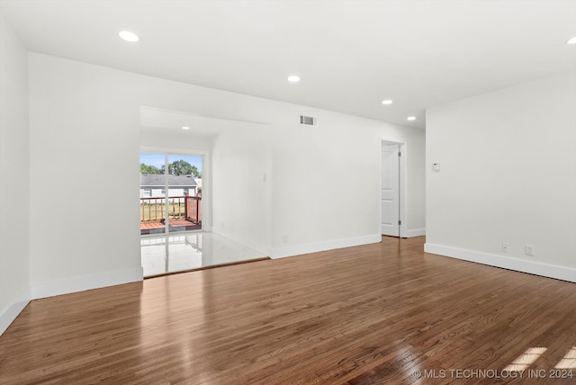 spare room featuring wood-type flooring