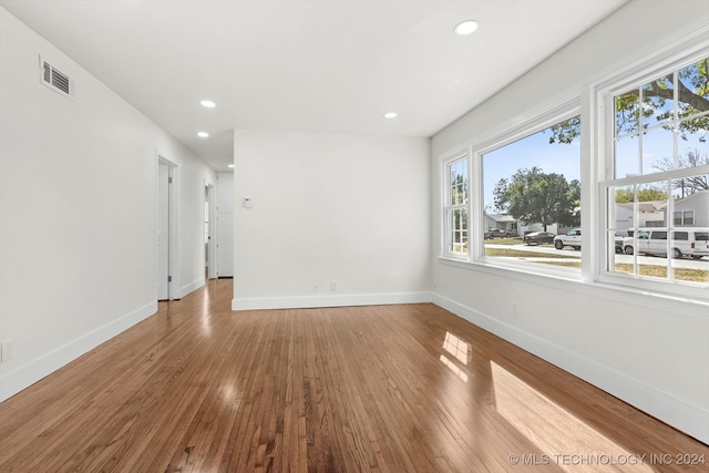 spare room with wood-type flooring