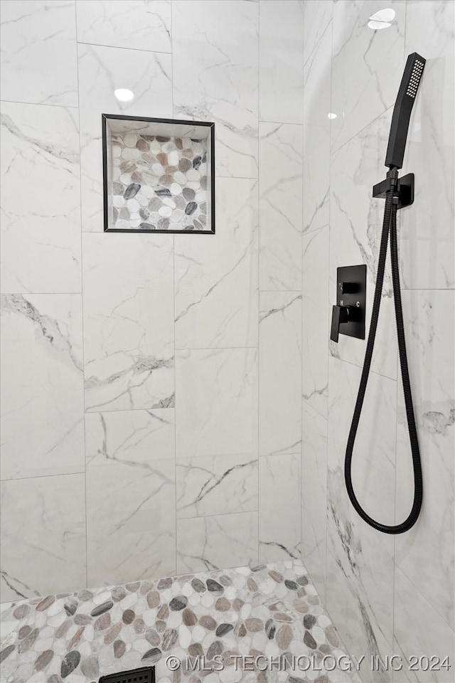 bathroom with a tile shower