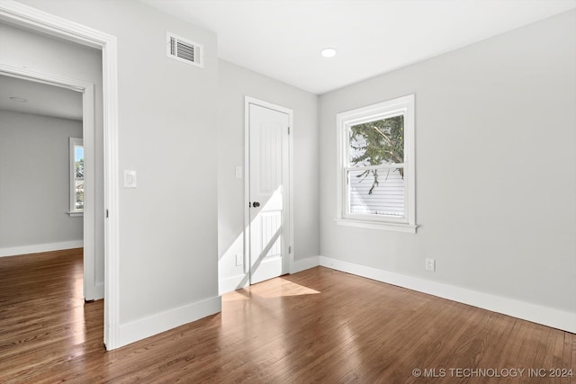 spare room featuring wood-type flooring