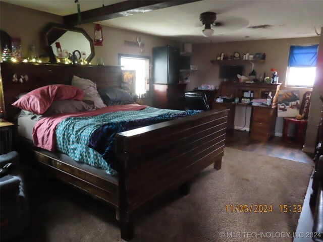 bedroom with hardwood / wood-style floors, ceiling fan, and fridge