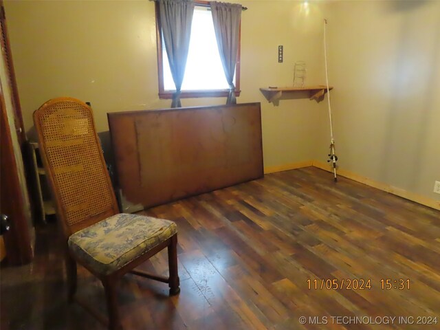 sitting room with dark hardwood / wood-style flooring