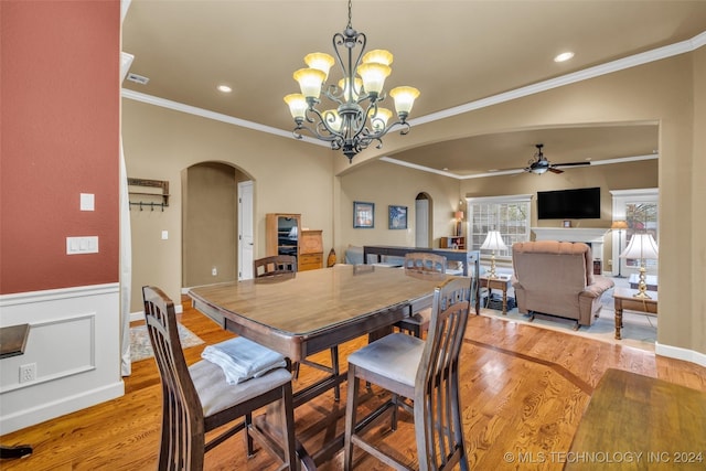 dining room featuring crown molding, ceiling fan with notable chandelier, and light wood-type flooring