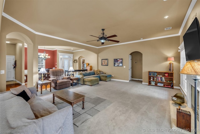 carpeted living room with ceiling fan with notable chandelier and ornamental molding