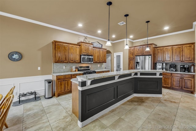 kitchen featuring light stone counters, stainless steel appliances, hanging light fixtures, and a center island with sink