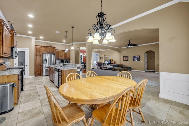 dining area featuring crown molding, ceiling fan, and light tile patterned flooring