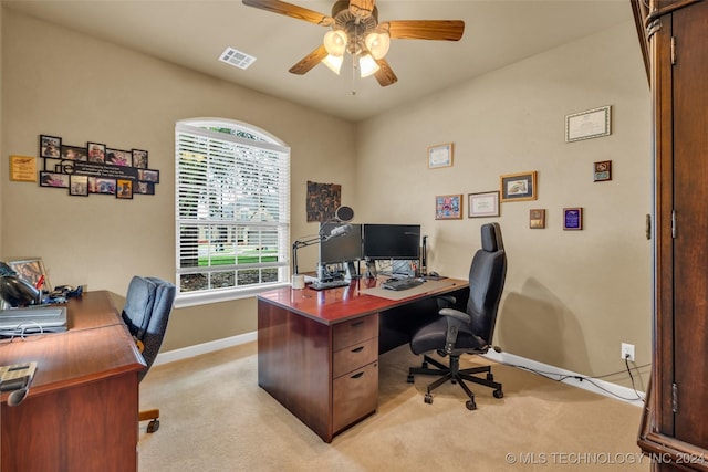 home office featuring ceiling fan, baseboards, visible vents, and light colored carpet