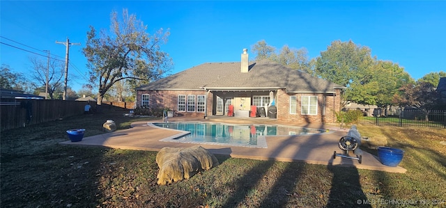 view of pool featuring a patio and a lawn