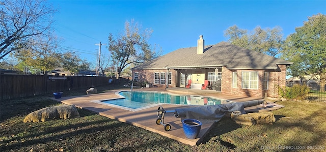 view of pool with a yard and a patio