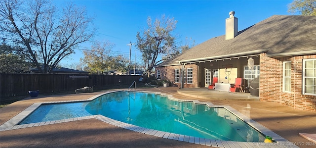 view of pool featuring a fenced in pool, french doors, a patio area, and a fenced backyard