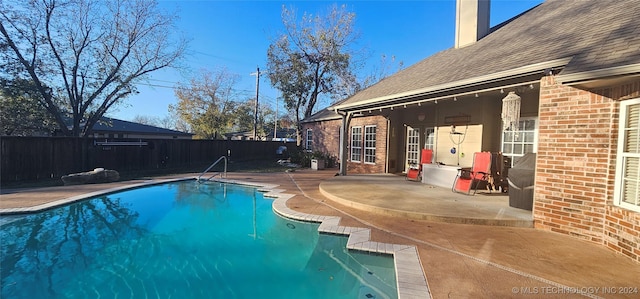 view of swimming pool with a fenced in pool, a fenced backyard, and a patio