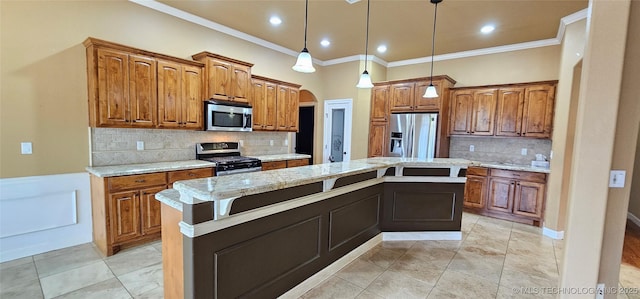 kitchen with crown molding, decorative light fixtures, a center island, appliances with stainless steel finishes, and light stone countertops