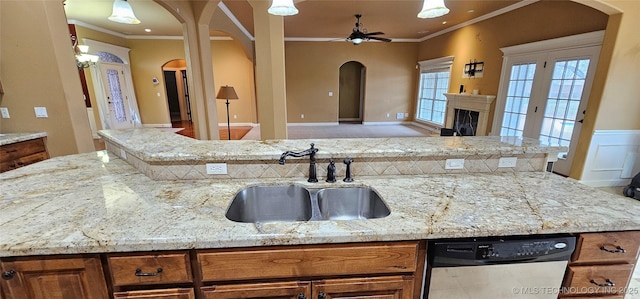 kitchen with light stone counters, sink, ornamental molding, and dishwasher