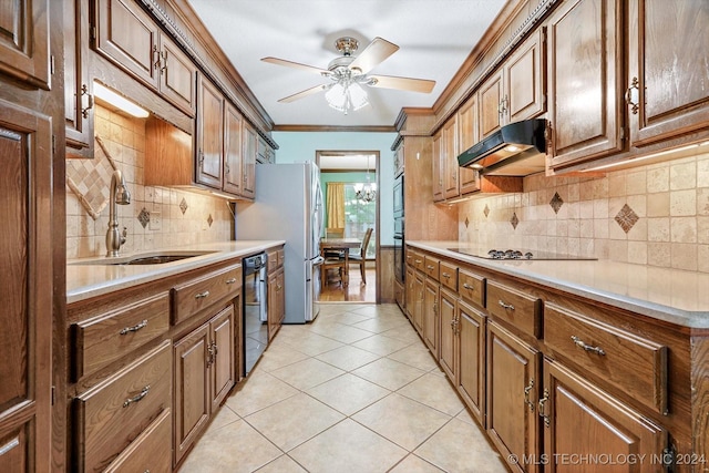 kitchen with sink, light tile patterned floors, ornamental molding, ceiling fan with notable chandelier, and black appliances