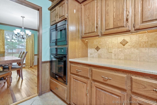 kitchen with crown molding, hanging light fixtures, tasteful backsplash, built in microwave, and oven