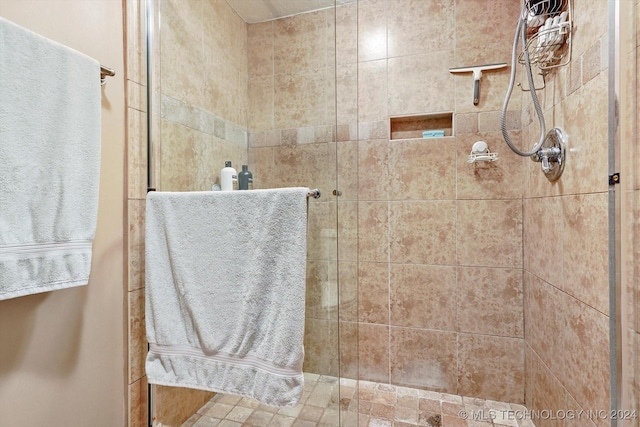 bathroom with a tile shower