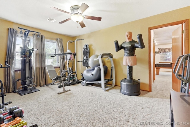 workout room featuring light colored carpet and ceiling fan