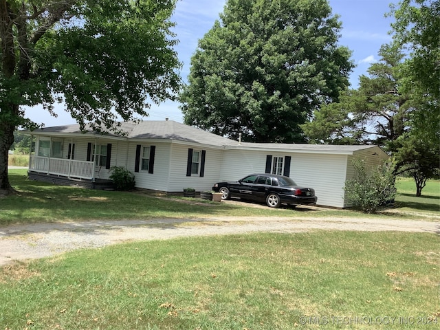 single story home featuring a front lawn and covered porch