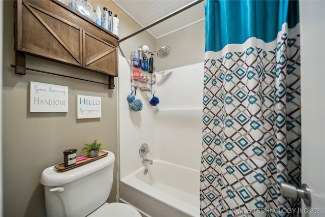 bathroom featuring shower / bath combination with curtain and toilet