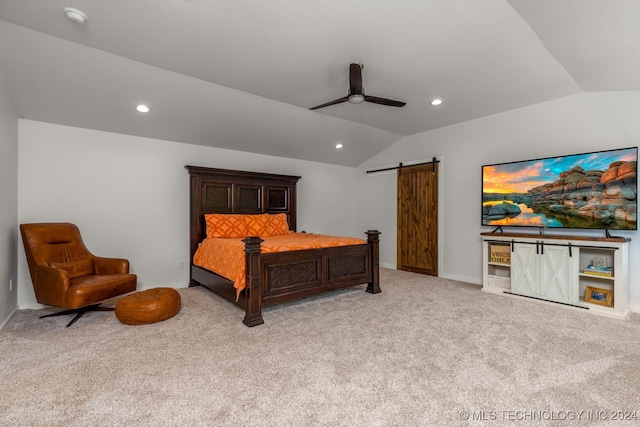 bedroom with light colored carpet, a barn door, vaulted ceiling, and ceiling fan