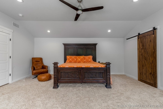 carpeted bedroom with lofted ceiling, a barn door, and ceiling fan