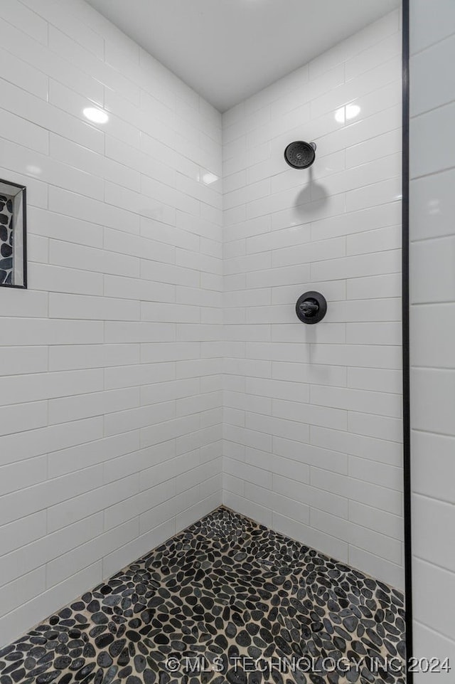 bathroom with a tile shower