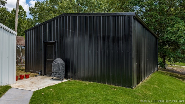 view of outbuilding with a yard