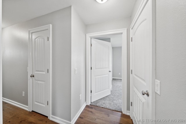 corridor with hardwood / wood-style flooring