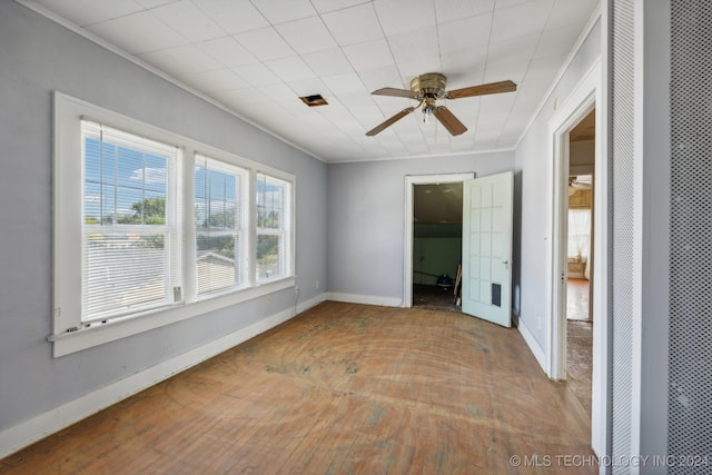 spare room with hardwood / wood-style flooring, ceiling fan, and crown molding