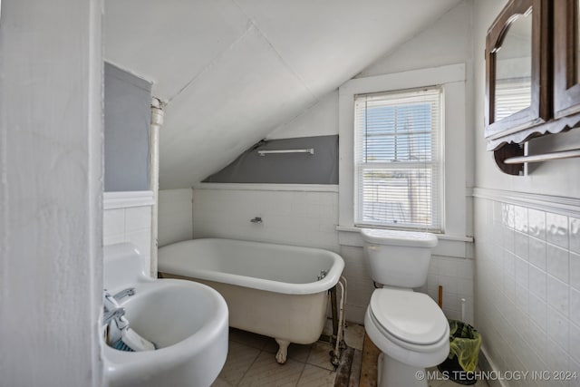 bathroom featuring tile walls, toilet, and vaulted ceiling