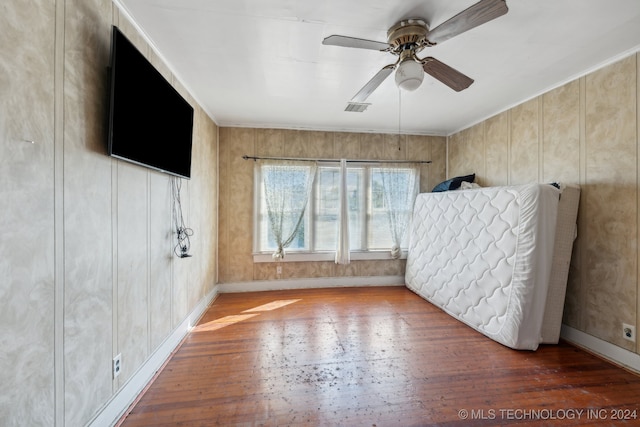 unfurnished bedroom with wood-type flooring and ceiling fan