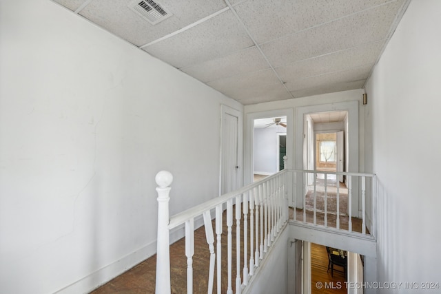 hallway featuring a paneled ceiling