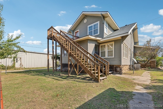 back of house with a lawn and a wooden deck