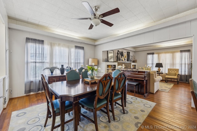 dining room with hardwood / wood-style flooring and ceiling fan