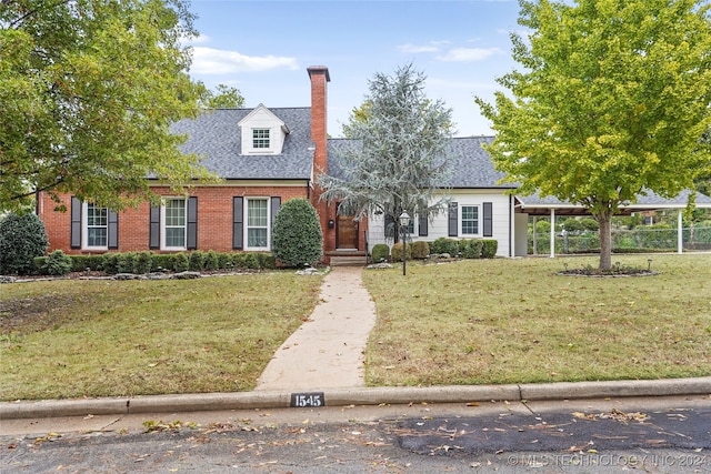 cape cod home with a front yard