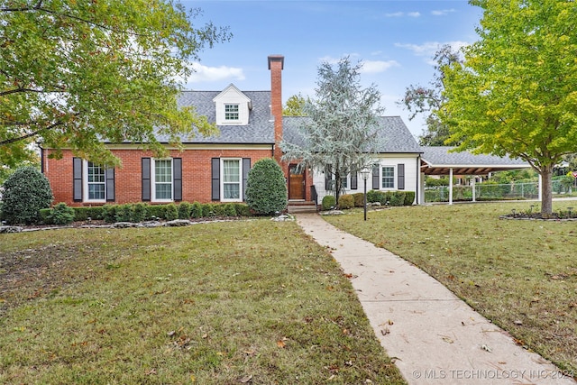 new england style home with a front yard and a carport