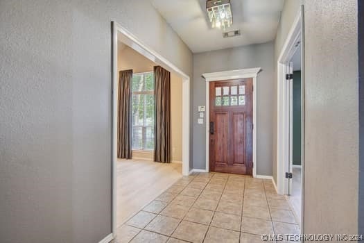 foyer featuring light tile patterned floors