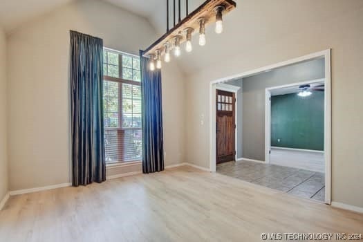 interior space featuring light hardwood / wood-style flooring, ceiling fan, and vaulted ceiling