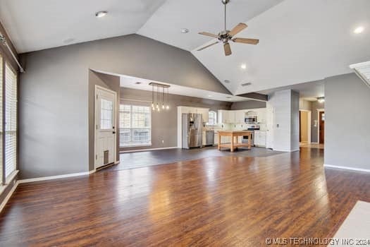 unfurnished living room featuring dark hardwood / wood-style flooring, high vaulted ceiling, and ceiling fan