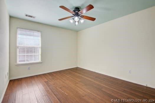 unfurnished room featuring hardwood / wood-style floors and ceiling fan