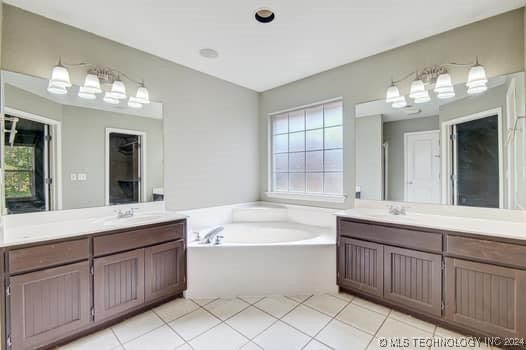 bathroom with vanity, a tub to relax in, and tile patterned floors