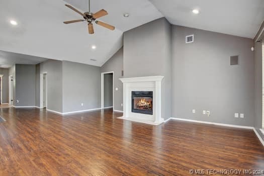 unfurnished living room featuring dark hardwood / wood-style flooring, ceiling fan, and high vaulted ceiling