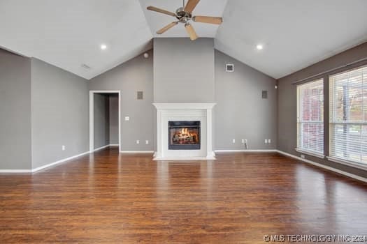 unfurnished living room with plenty of natural light and dark hardwood / wood-style floors