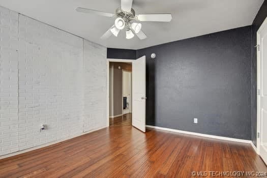 unfurnished room featuring hardwood / wood-style floors and ceiling fan