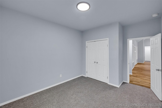 unfurnished bedroom featuring carpet floors and a closet