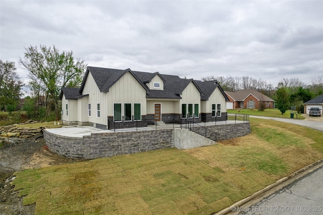 modern farmhouse style home with a patio area and a front yard