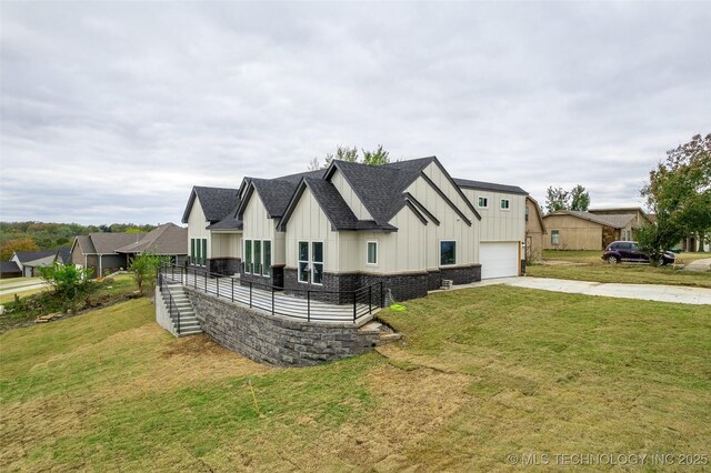 view of side of home featuring a lawn and a garage