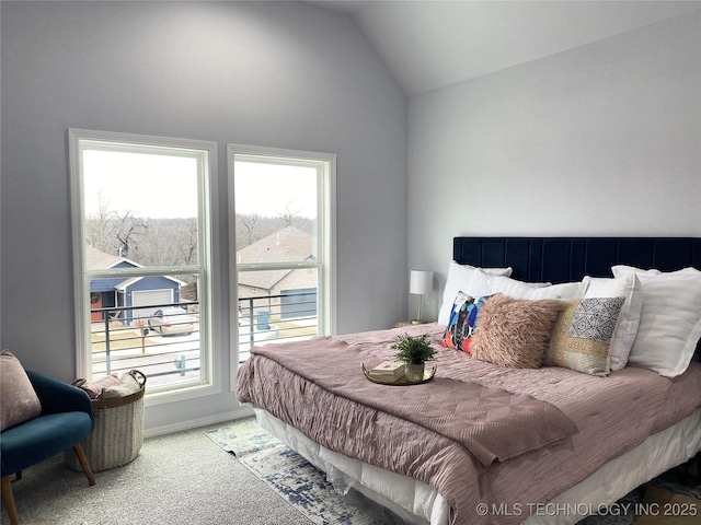 bedroom featuring carpet flooring and lofted ceiling